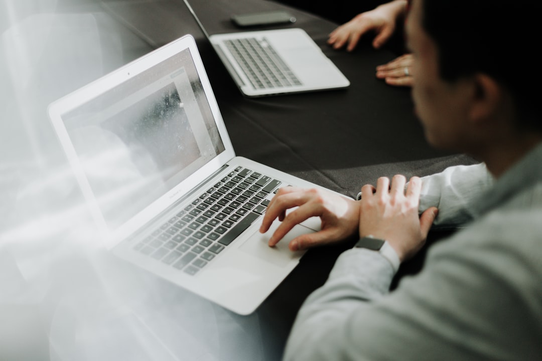 Professional using laptop for background screening